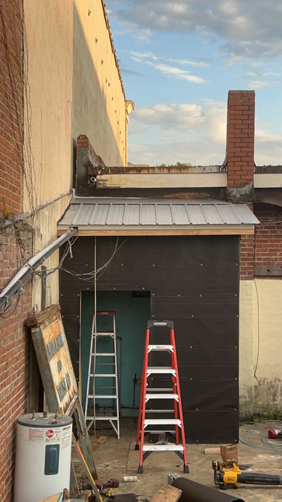 Metal roof and exterior wall work on a renovation project