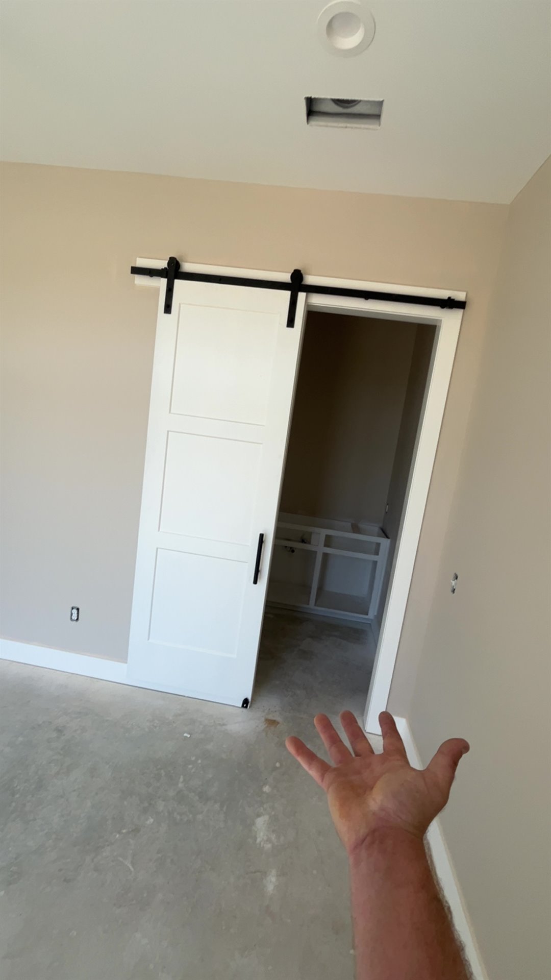 White sliding barn door installed on a black track